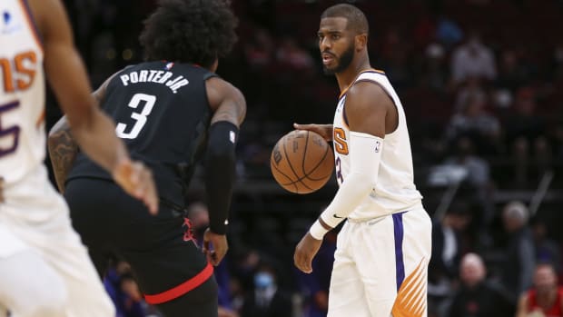 Nov 14, 2021; Houston, Texas, USA; Phoenix Suns guard Chris Paul (3) controls the ball as Houston Rockets guard Kevin Porter Jr. (3) defends during the first quarter at Toyota Center. Mandatory Credit: Troy Taormina-USA TODAY Sports